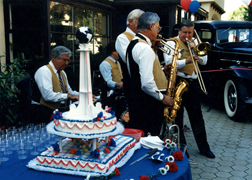 A band playing 1930's music, a custom-designed cake and antique cars are part of the celebration